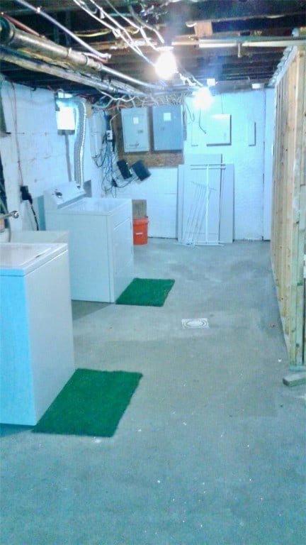 basement featuring washer and dryer and electric panel