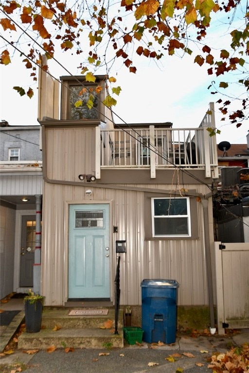 view of exterior entry with a balcony