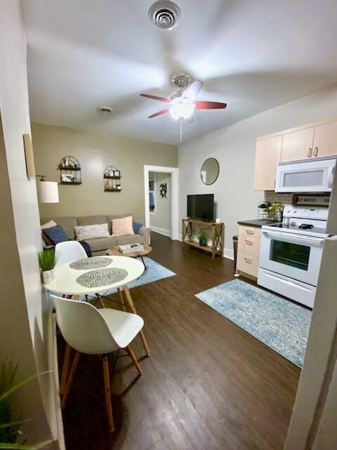 interior space featuring ceiling fan and dark hardwood / wood-style flooring