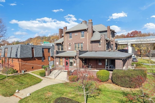 rear view of property with a lawn