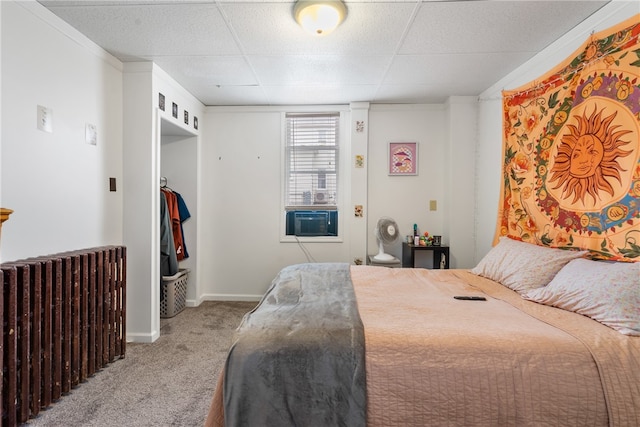 bedroom with cooling unit, a paneled ceiling, crown molding, and carpet floors