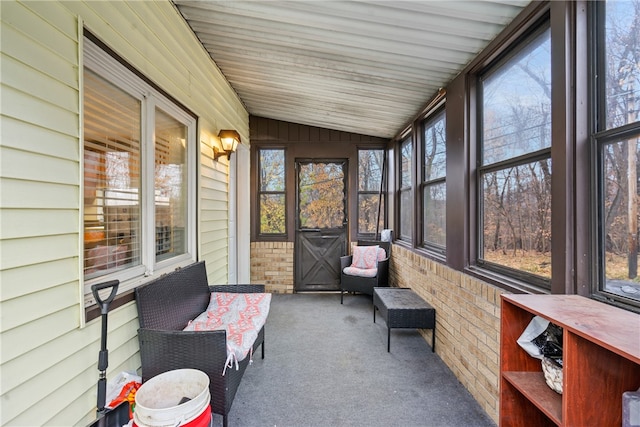 sunroom / solarium featuring lofted ceiling