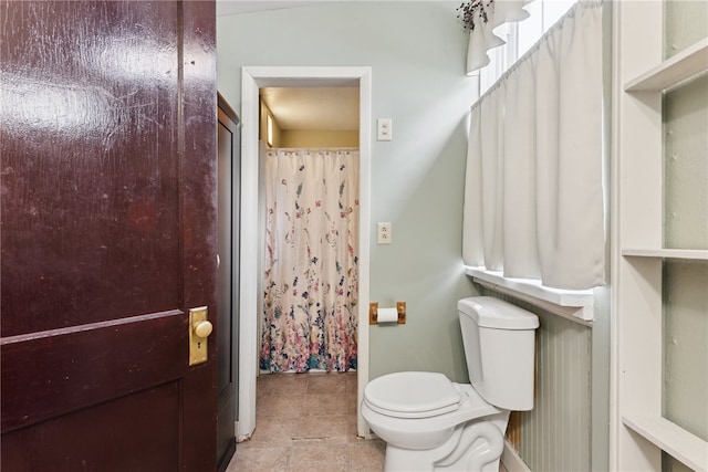 bathroom with tile patterned flooring and toilet