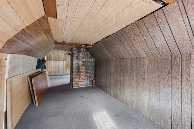 additional living space featuring wood walls, lofted ceiling, and wood ceiling