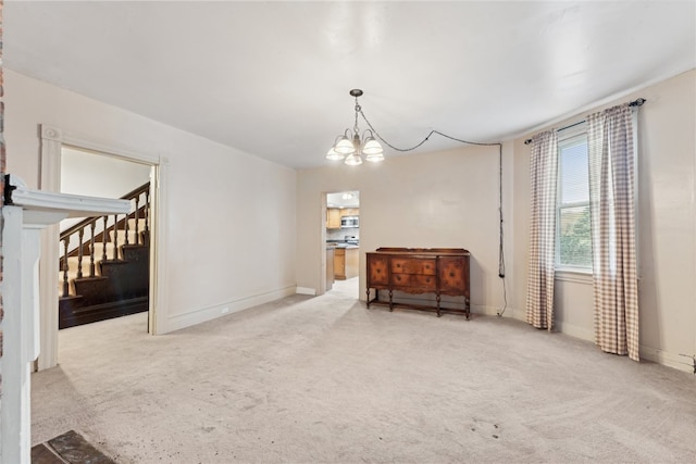 living area featuring light colored carpet and a chandelier