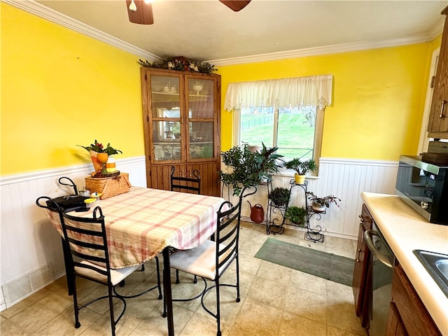 dining space with ceiling fan and ornamental molding