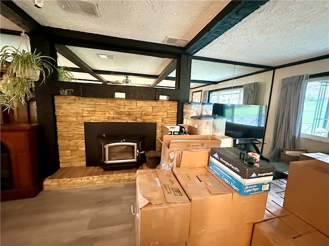 living room featuring vaulted ceiling with beams, wood-type flooring, and a textured ceiling