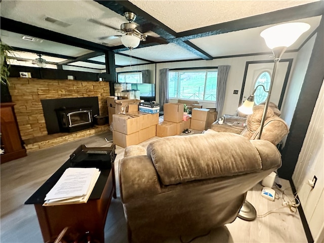 interior space with vaulted ceiling with beams, ceiling fan, light wood-type flooring, and a textured ceiling