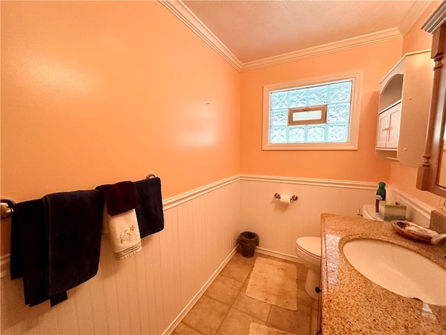 bathroom featuring crown molding, vanity, a textured ceiling, and toilet