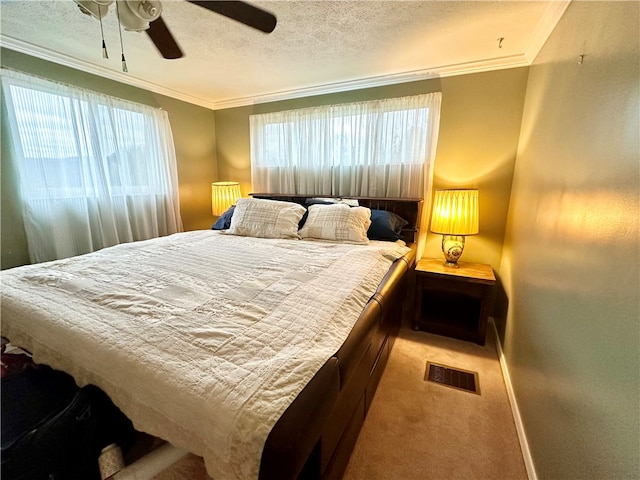 carpeted bedroom with a textured ceiling, ceiling fan, crown molding, and multiple windows