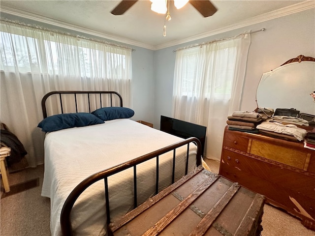 bedroom with carpet, ceiling fan, and ornamental molding