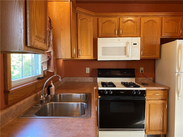 kitchen featuring sink and white appliances