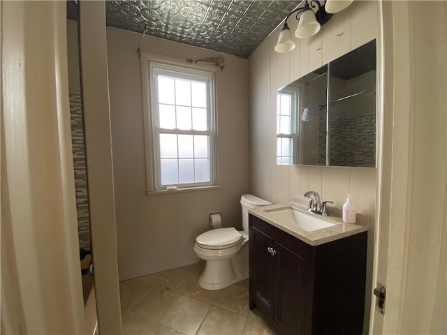 bathroom featuring vanity, toilet, and curtained shower