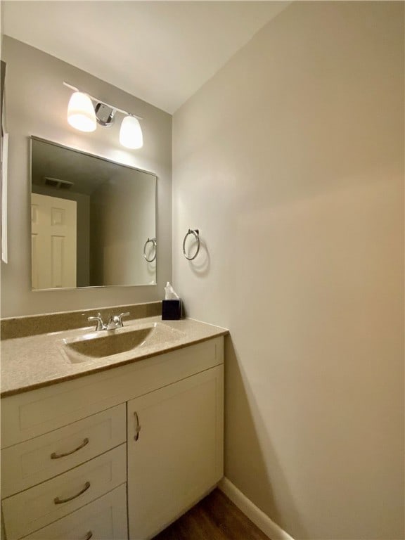 bathroom featuring hardwood / wood-style flooring and vanity