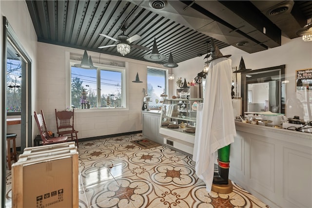 sunroom featuring ceiling fan