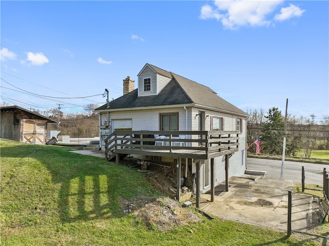 rear view of property with a yard and a wooden deck