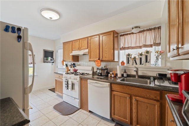 kitchen with backsplash, white appliances, sink, and light tile patterned floors