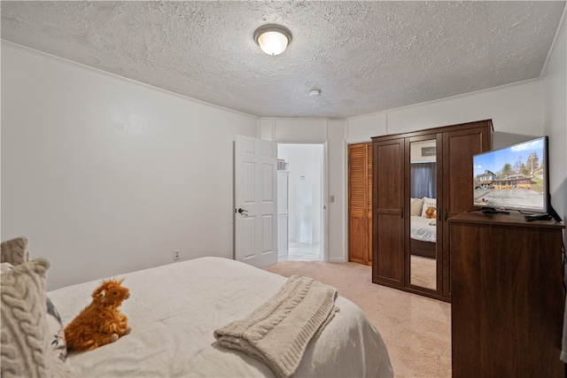 carpeted bedroom featuring a textured ceiling