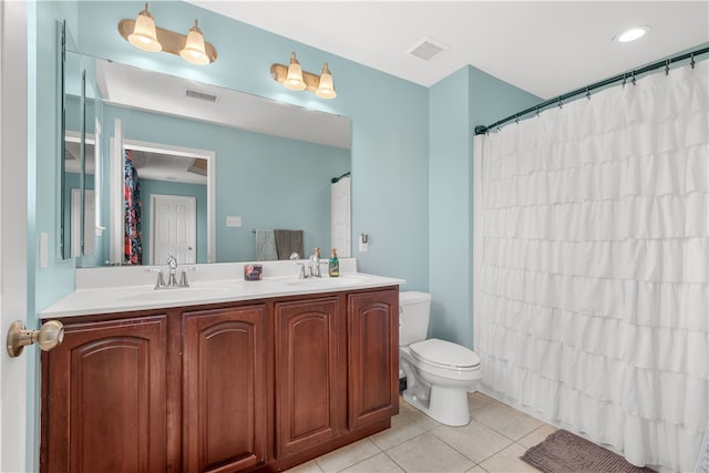 bathroom featuring tile patterned flooring, a shower with curtain, vanity, and toilet