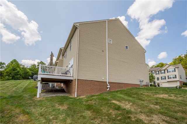 view of property exterior with a deck and a lawn