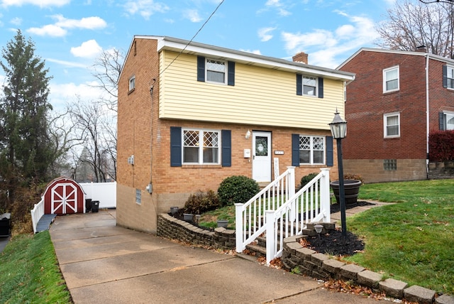 view of front property with a front yard and a storage unit