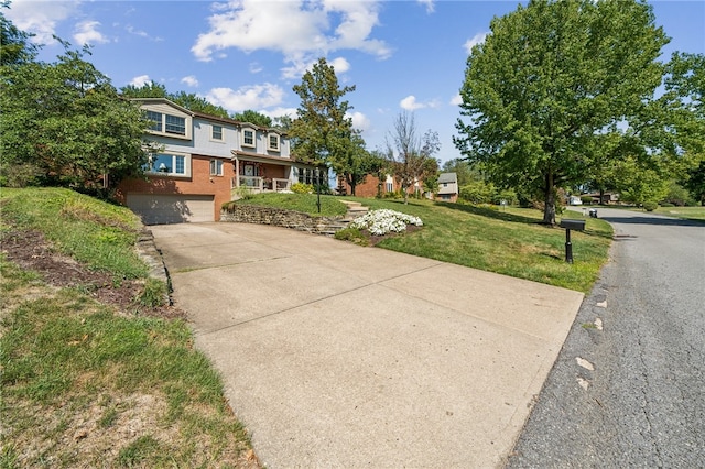 view of front of home with a garage and a front yard