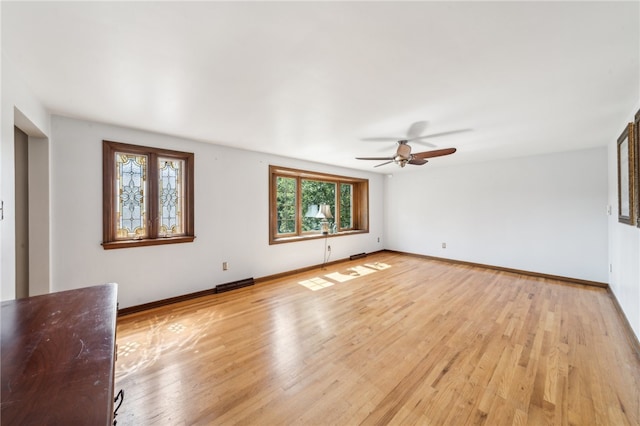 unfurnished living room with a wealth of natural light, ceiling fan, and light hardwood / wood-style floors