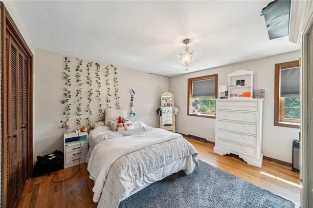 bedroom with light wood-type flooring and a closet