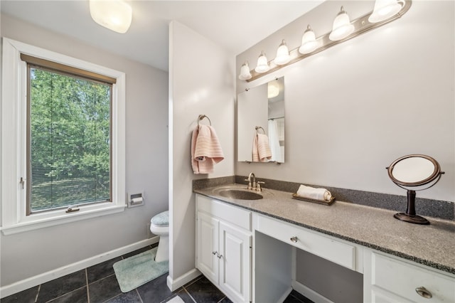 bathroom featuring tile patterned floors, vanity, and toilet