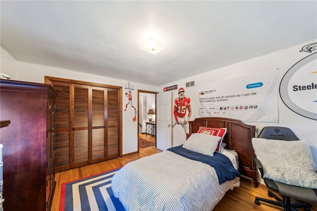 bedroom with wood-type flooring and a closet