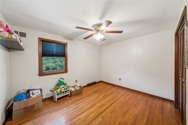 unfurnished bedroom featuring hardwood / wood-style flooring, ceiling fan, and a closet