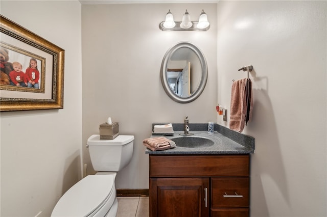 bathroom with tile patterned floors, vanity, and toilet