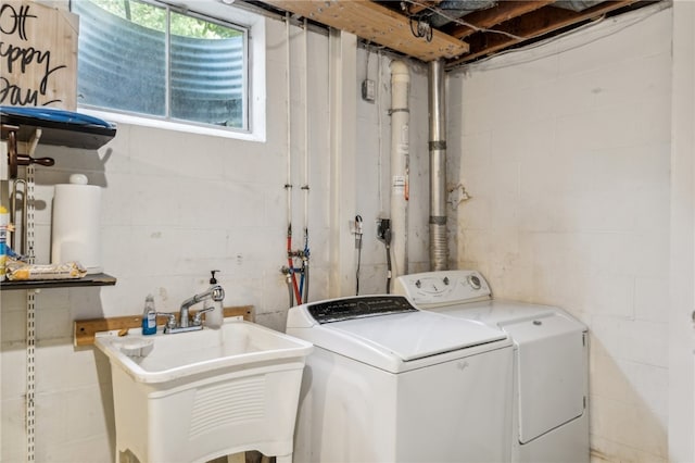 laundry room featuring washing machine and dryer and sink