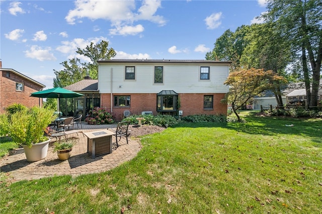 back of property with a yard and a patio