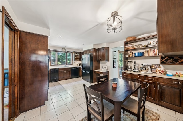 tiled dining area featuring sink and an inviting chandelier