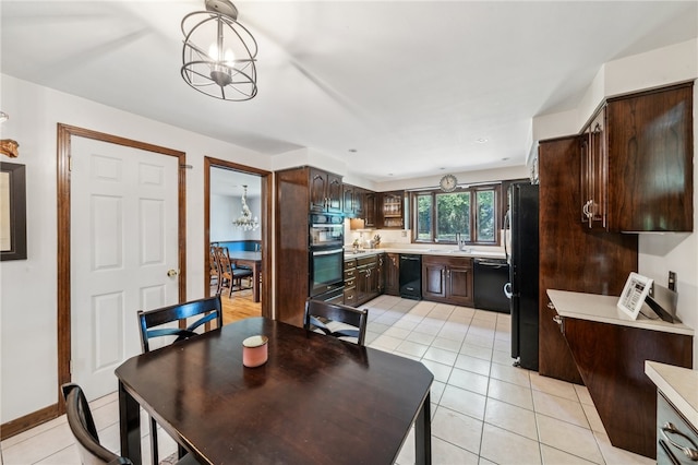 tiled dining area with sink and a notable chandelier