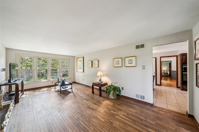 sitting room with hardwood / wood-style flooring