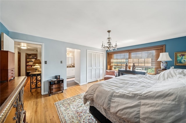 bedroom with a closet, light hardwood / wood-style flooring, ensuite bathroom, and an inviting chandelier