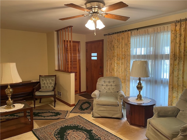 sitting room featuring ceiling fan