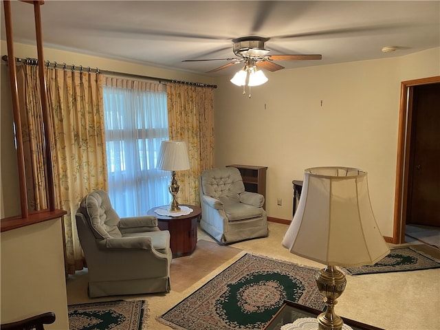 sitting room featuring light carpet and ceiling fan