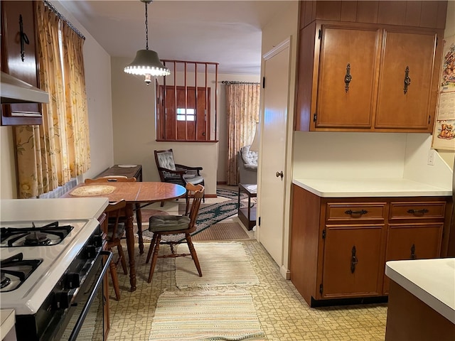 kitchen with decorative light fixtures and white gas stove