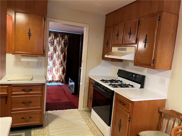 kitchen featuring white gas range oven and range hood