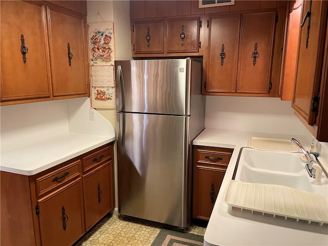 kitchen with stainless steel fridge and sink