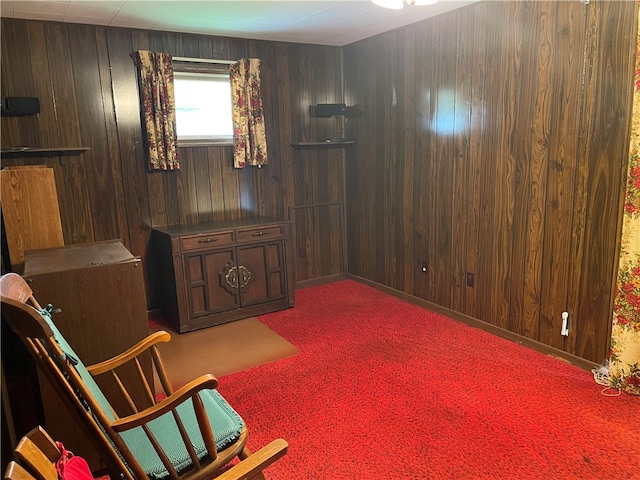 living area featuring wooden walls and carpet floors