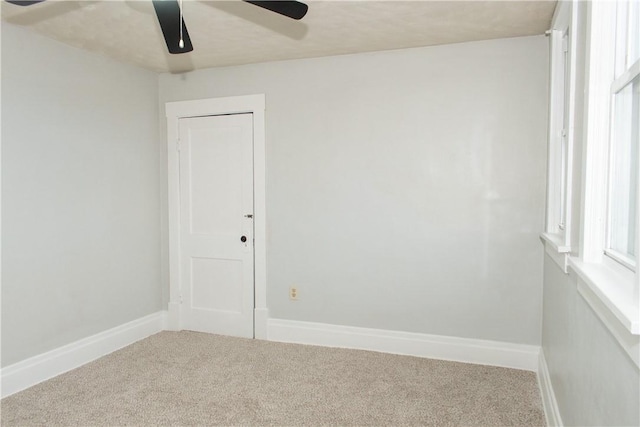 spare room with carpet, ceiling fan, and a wealth of natural light