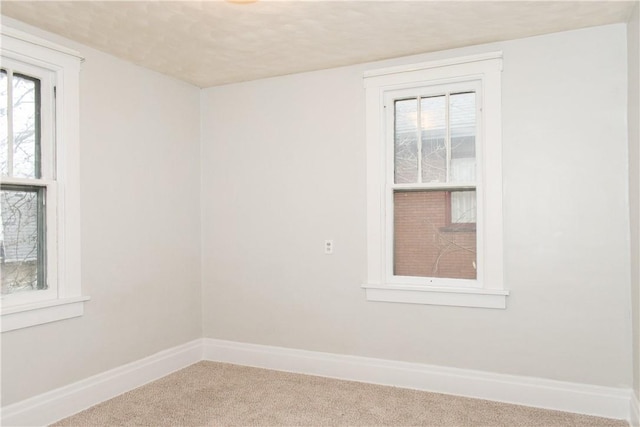 carpeted empty room with a healthy amount of sunlight