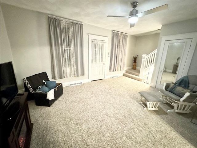 sitting room with carpet and ceiling fan