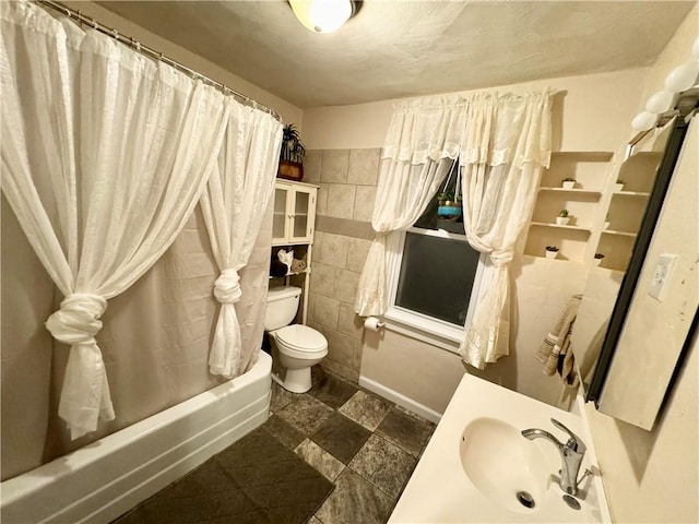 full bathroom with toilet, shower / bath combo with shower curtain, and sink