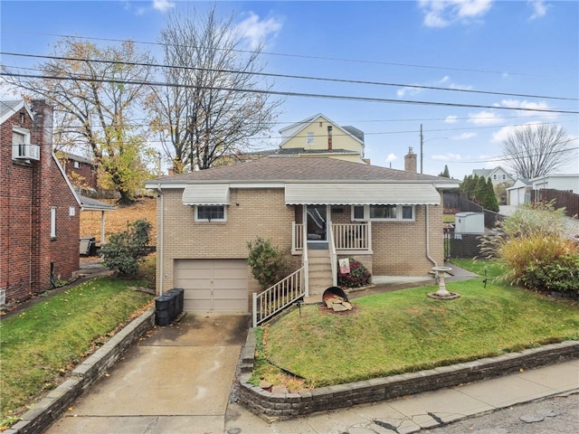 bungalow featuring a front yard and a garage