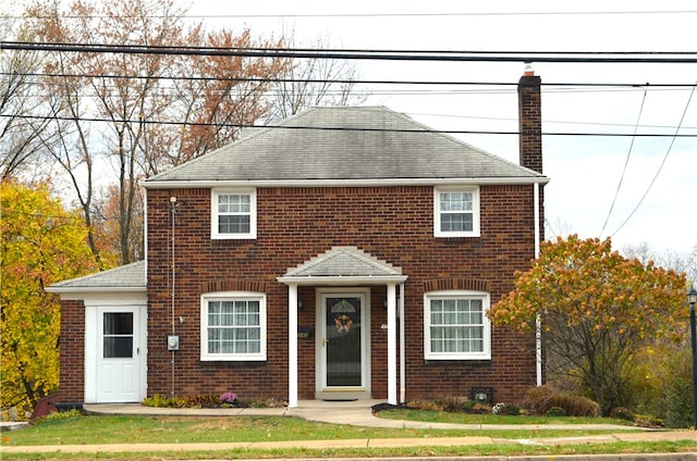 colonial inspired home with a front lawn